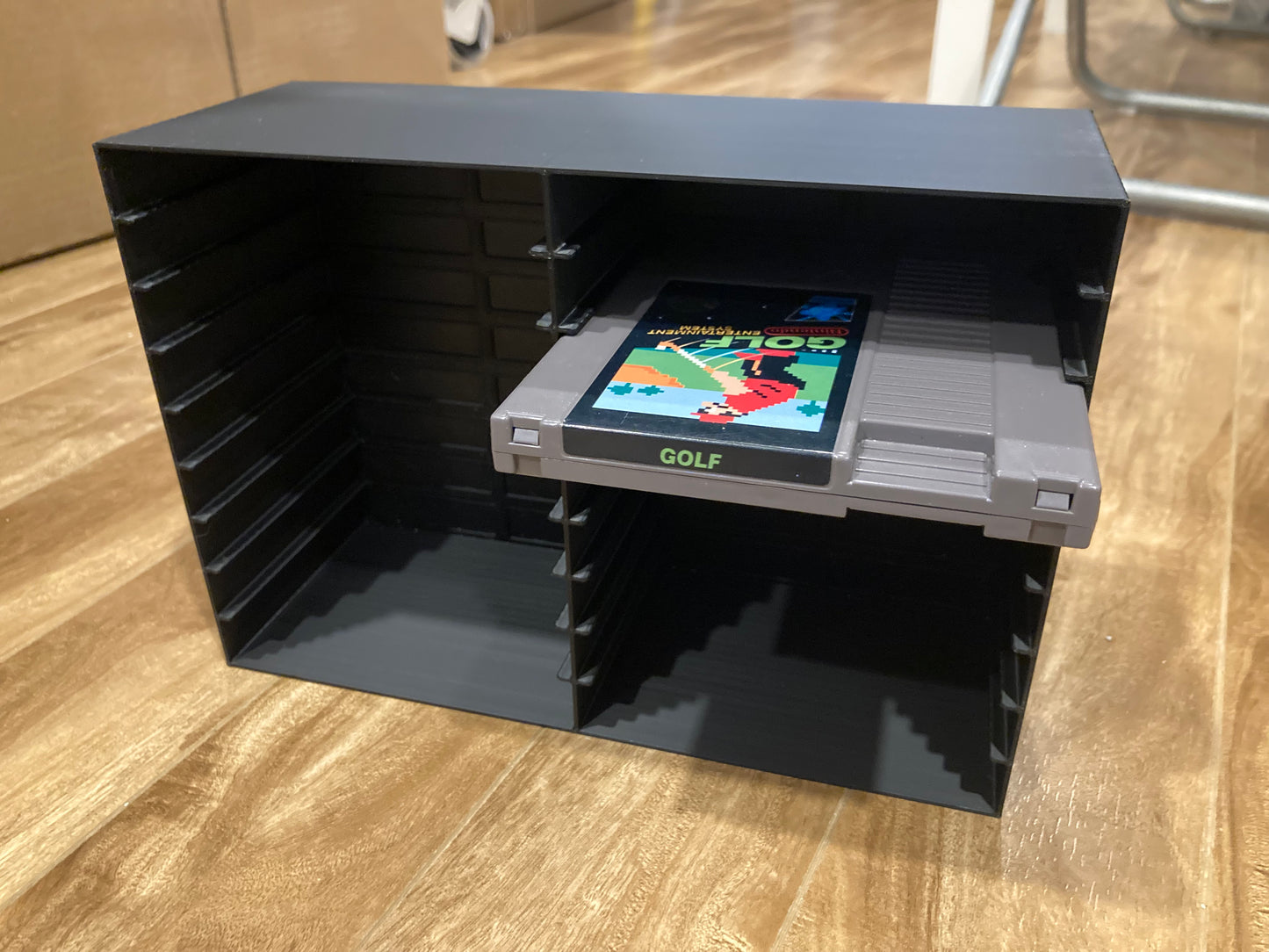 NES rack display - Holds 18 games NOT SLEEVED - Black color - Closed back - Perfect condition