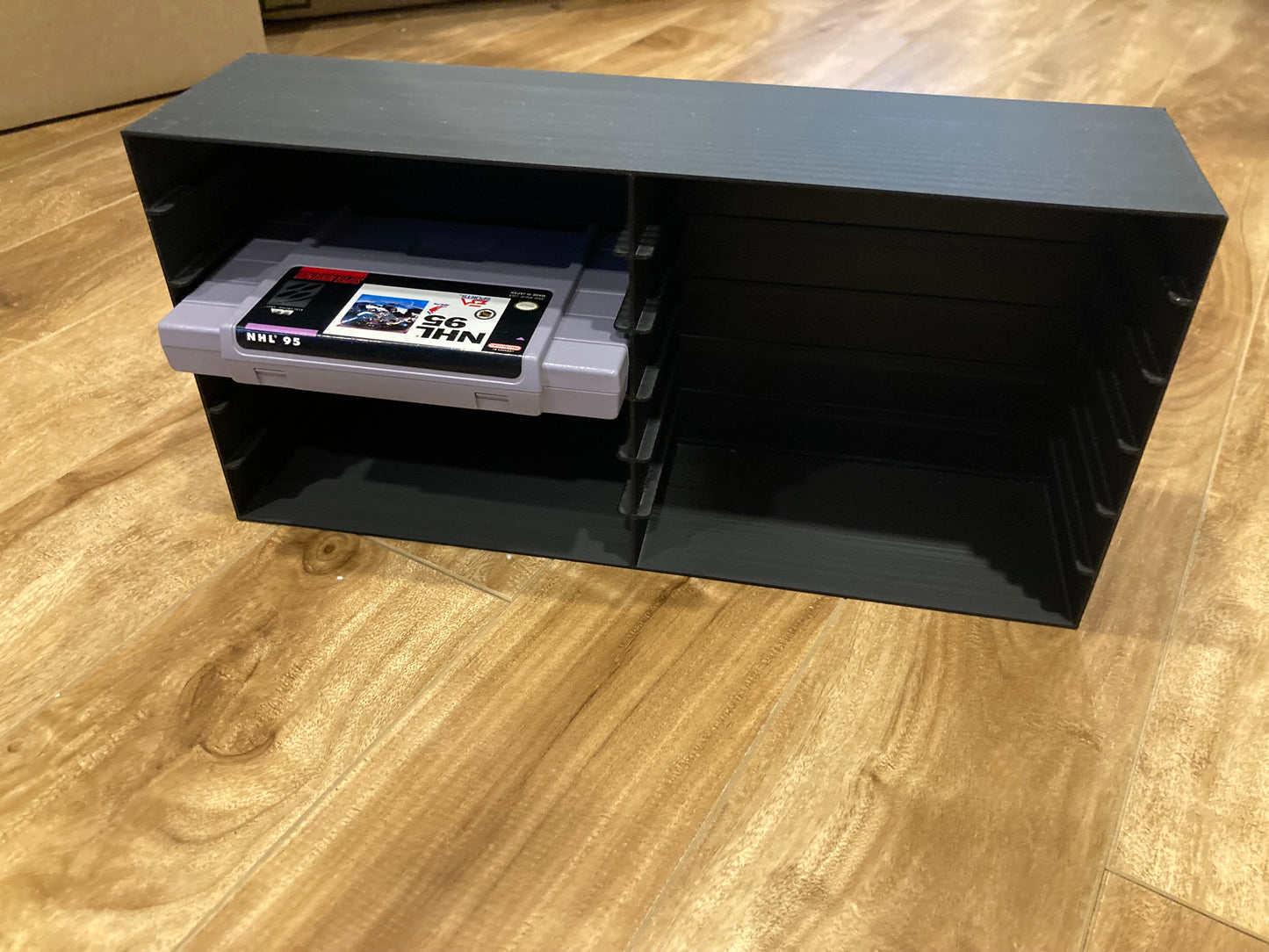SNES rack display - Holds 12 games - Closed back - Black color - Perfect condition