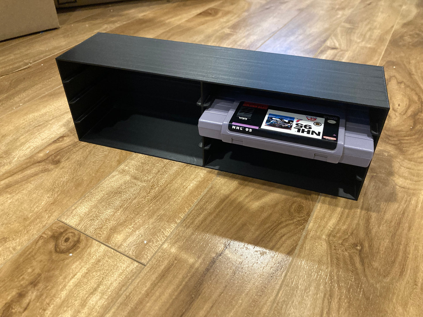 SNES rack display - Holds 8 games - Closed back - Black color - Perfect condition